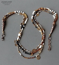 ozdobny naszyjnik, stonowane w odcieniach złot-brązowo-czarno-beżowych przeplatające się wzajemnie w 3 sznurach śliczne drobniutkie koraliki